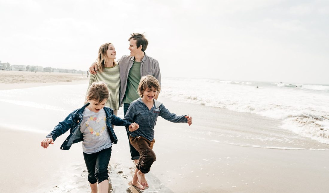 Family walking together on the beach