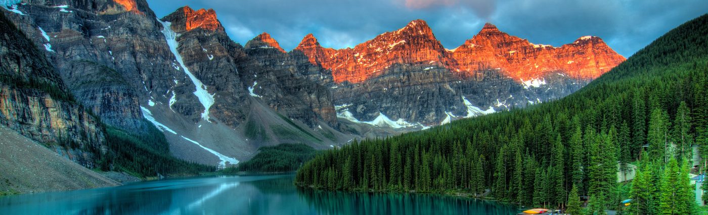 Mountain range at sunrise reflected in a lake